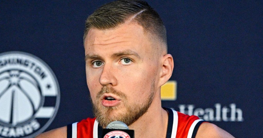 Kristaps Porzingis speaking at a press conference — the Warriors star is the subject of trade rumors as he battles POTS